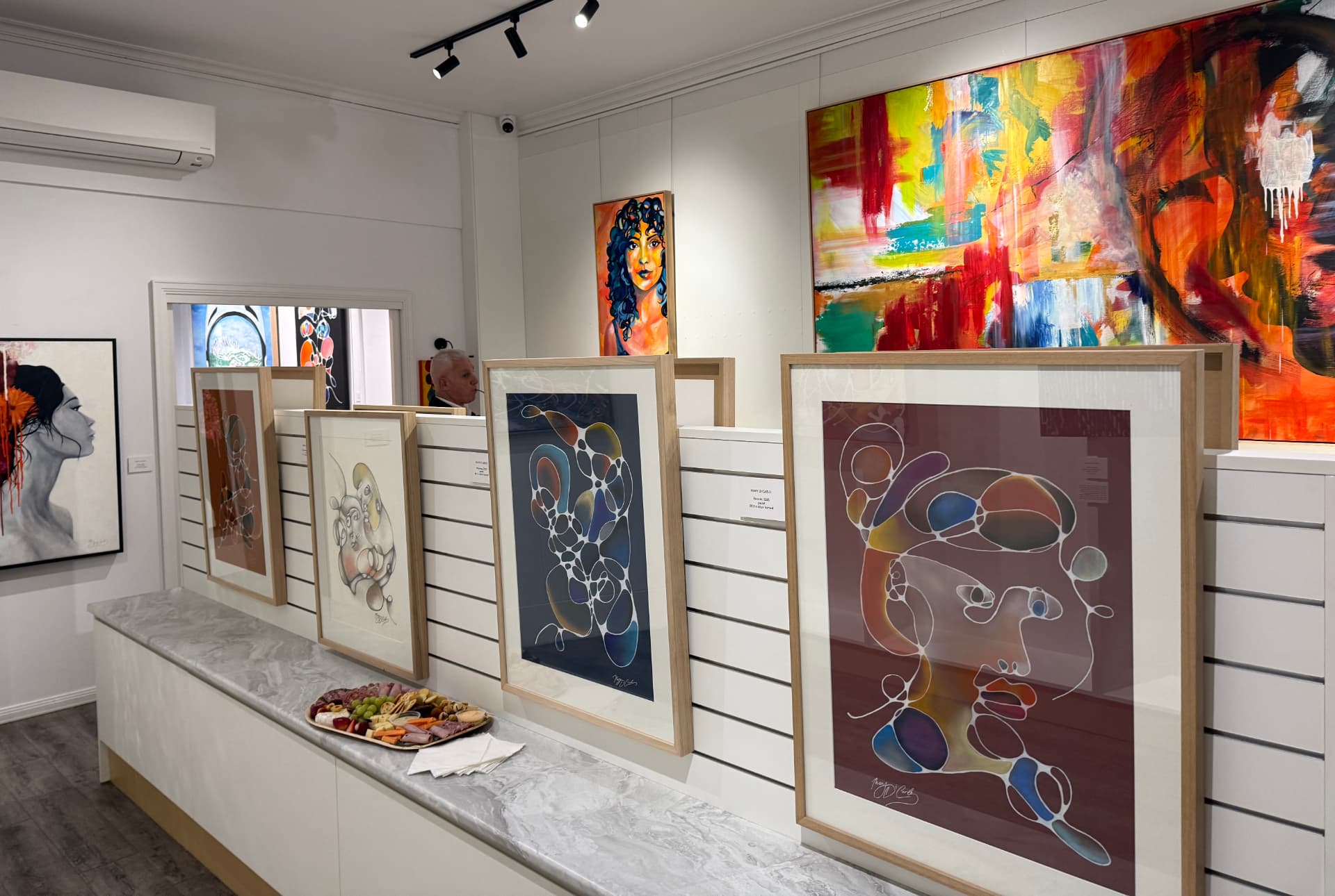 Framed artworks displayed at KIMS SPACE